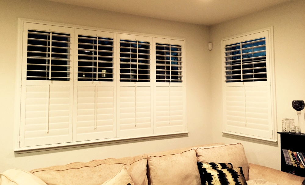 shutters covering two windows in a living room